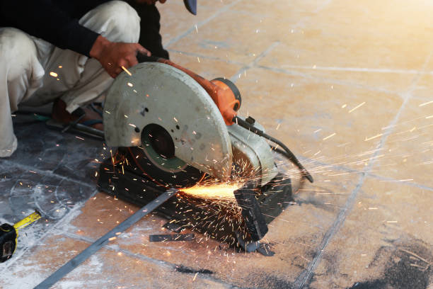 istock Close-up of worker cutting metal with grinder. Sparks while grinding iron. 957412306