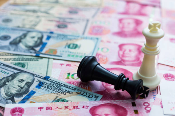 istock Chess kings standing on dollar and China yuan 957415188