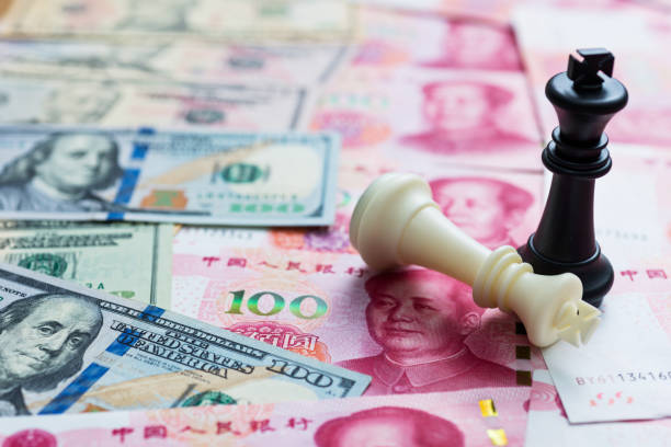istock Chess kings standing on dollar and China yuan 957415316