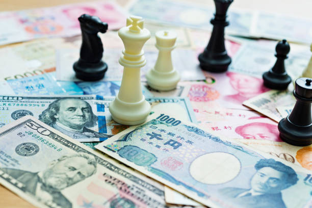 istock Chess pieces and paper currency 957415628