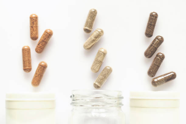 istock Medicinal capsule spill out of a three plastic bottles 957415826
