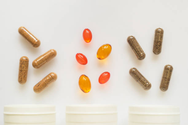 istock Medicinal capsule spill out of a three plastic bottles 957415988