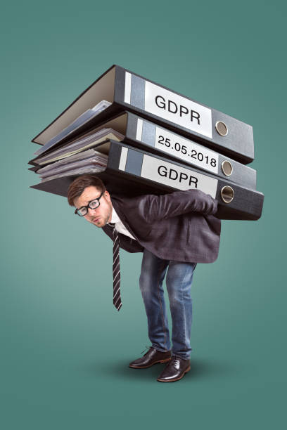 istock Man carrying an enormous stack of GDPR files 957416076