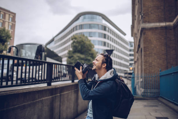 One man in London, photographer taking pictures on the city streets.