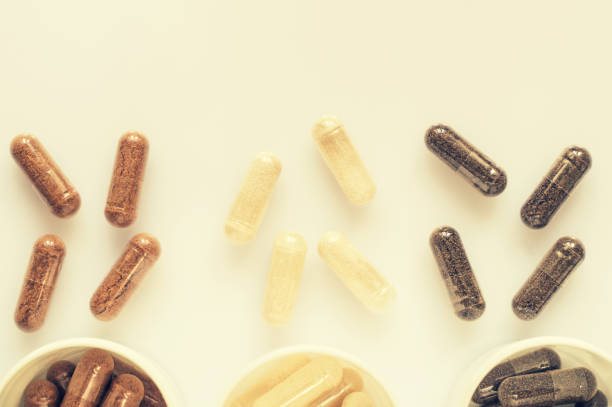 istock Medicinal capsule spill out of a three plastic bottles 957421808