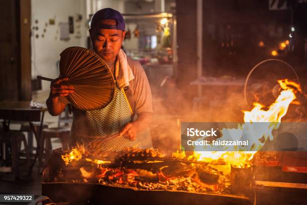 A Man Grilling Satay By The Street Stock Photo - Download Image Now - Malaysia, Street Food, Satay