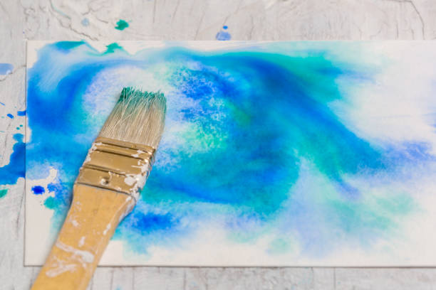 istock Grunge watercolor Background Texture - Blue with paintbrush 957433116