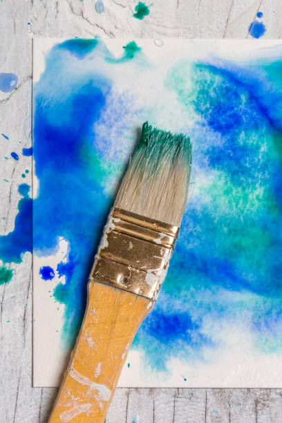 istock Grunge watercolor Background Texture - Blue with paintbrush 957433184
