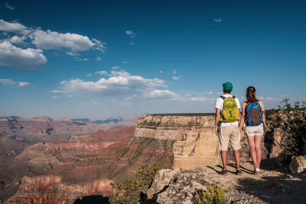 istock Tourists with backpack hiking at Grand Canyon 957439742