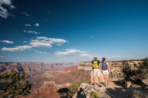 istock Tourists with backpack hiking at Grand Canyon 957439808
