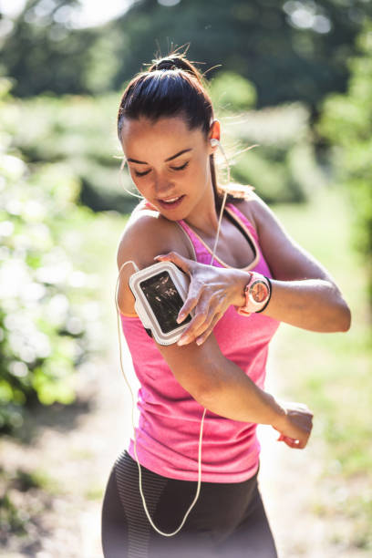 istock Young woman using smartwatch and smartphone 957444356