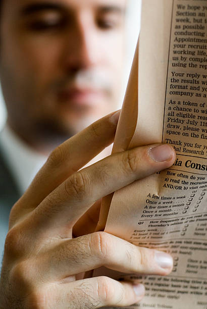 Businessman reading newspaper stock photo