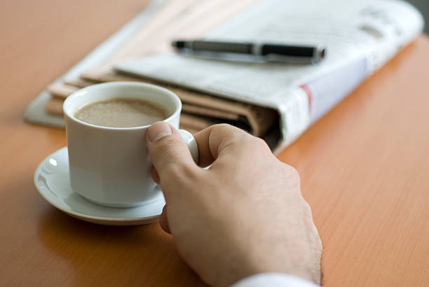istock Businessman sitting at table and drinking coffee, close-up 95745171