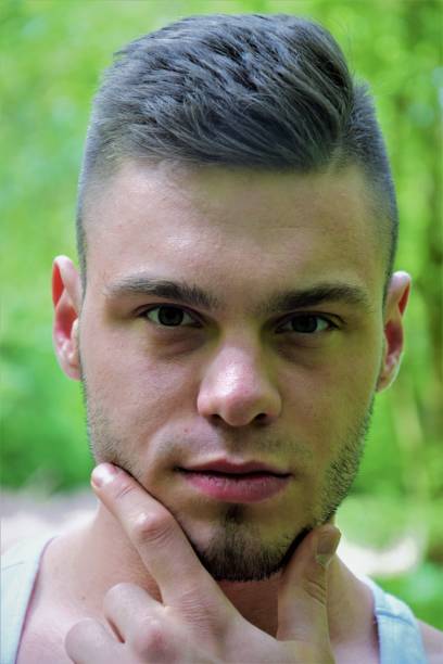 face of a young handsome man with seductive eyes. Close up