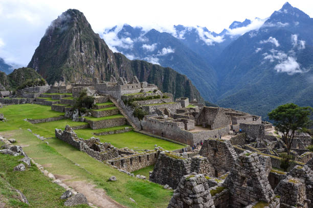 machu pichu view from above machu pichu view from above with clouds. Tourists are walking through the old abandoned city. inca photos stock pictures, royalty-free photos & images