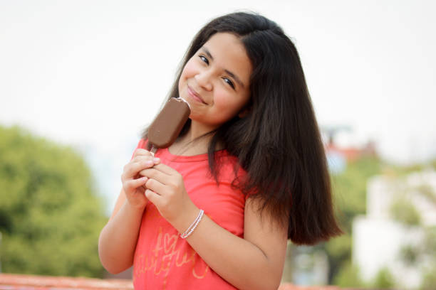 Girl eating a chocolate popsicle