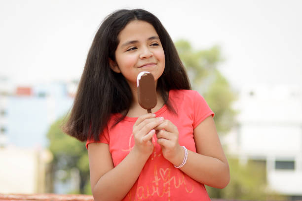 istock Girl Eating Ice Popsicle 957459784
