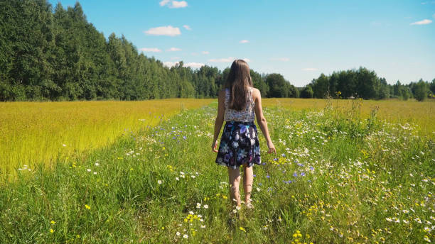 istock Girl walking on the field 957463236