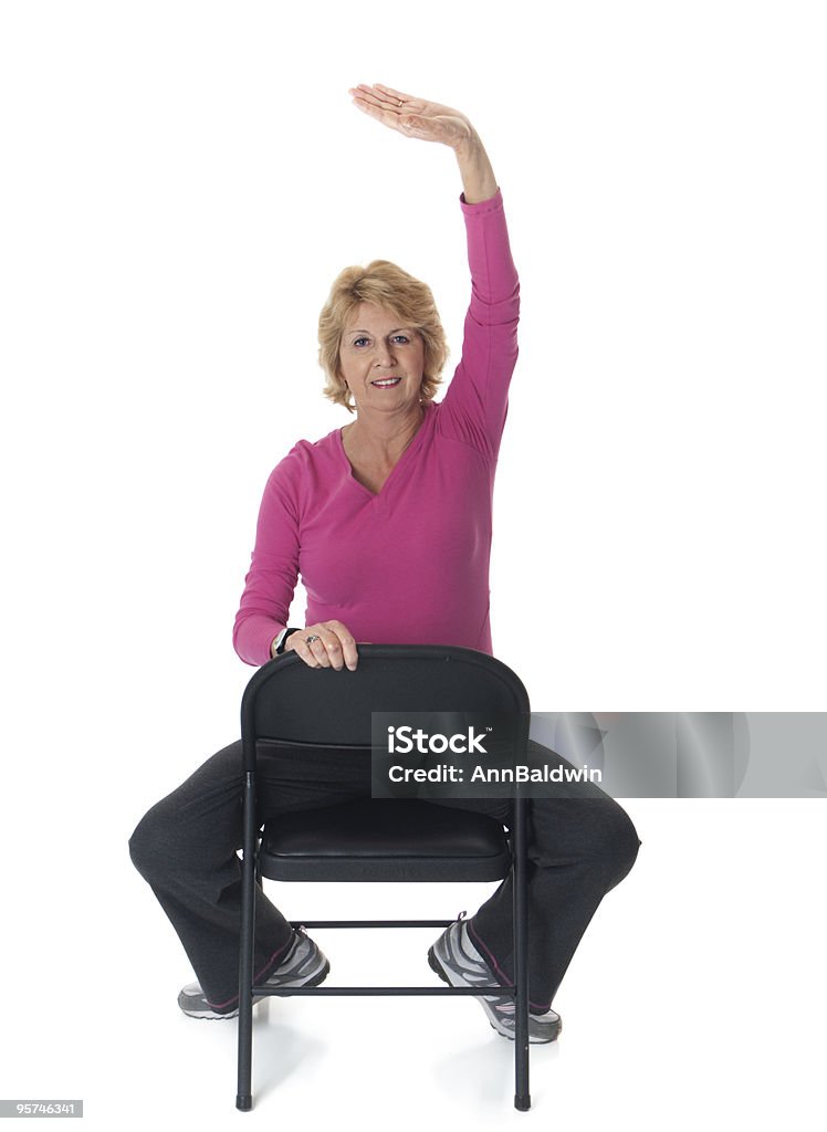 Femme âgée faisant de l'exercice en position assise - Photo de Chaise libre de droits