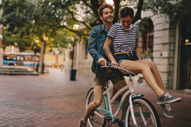 istock Happy couple on a bicycle in the city 957464228