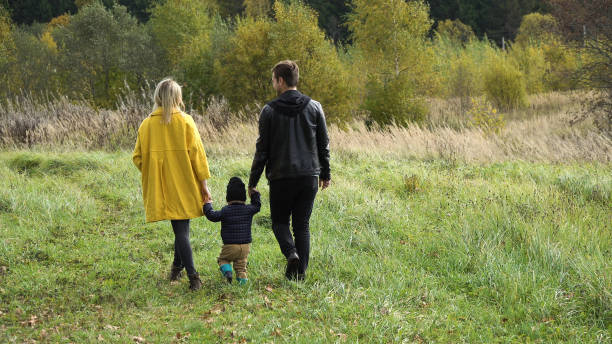 istock Young family on a walk in the park 957464290