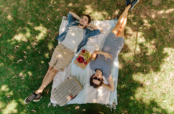 istock Couple relaxing on a picnic at park 957467610