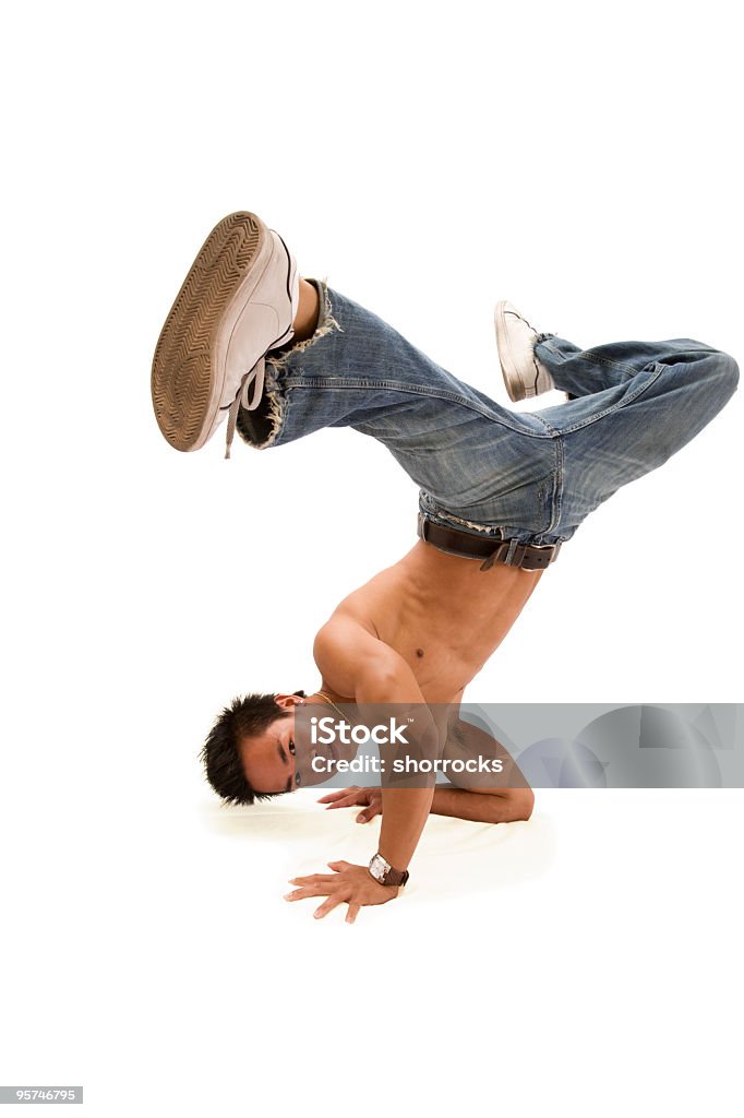 Break Dancing Full length portrait of a hip young adult man holding a break dancing pose against a white background; soft shadow beneath head and chest; copy space  Kicking Stock Photo