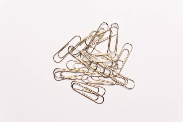 istock Metal paperclips on white background 957468394