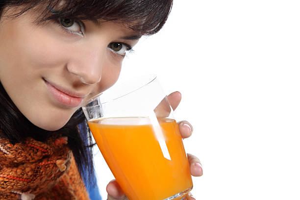 istock Beautiful young woman drinking juice 95747203
