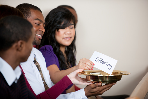 People giving tithes and offerings in church - Buy credits