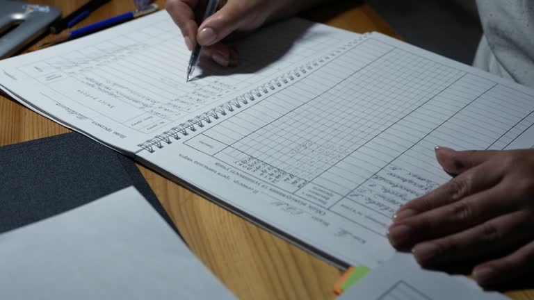 the woman fills the report. under the light of a lamp