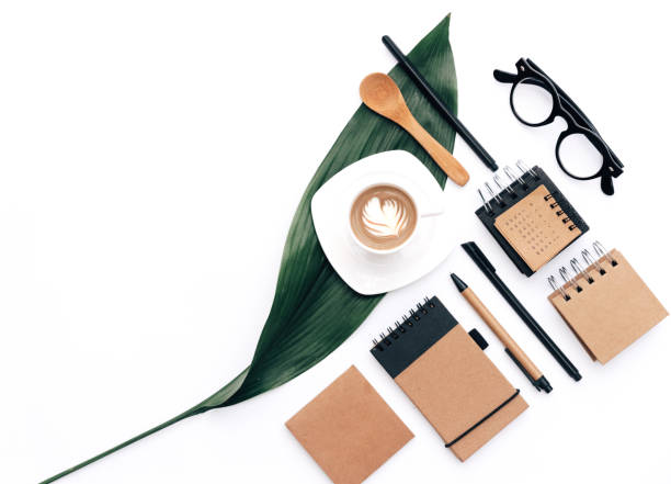 istock Modern blogger concept. Workspace with eco Kraft items coffee and green leaf on white background. Home office desk. Flat lay 957482398