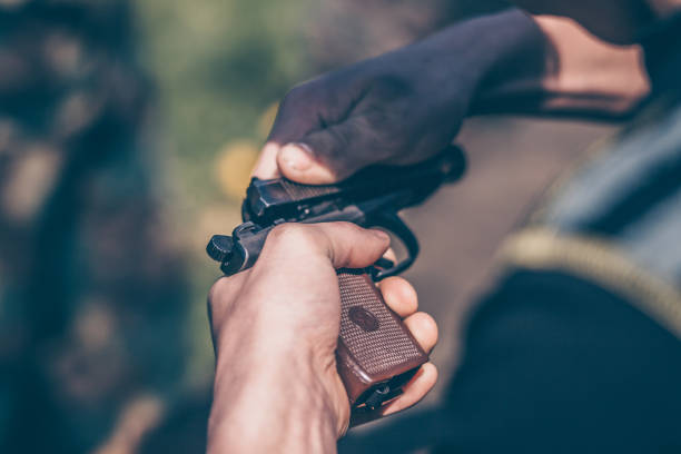 The instructor shows how to disassemble and assemble a pistol