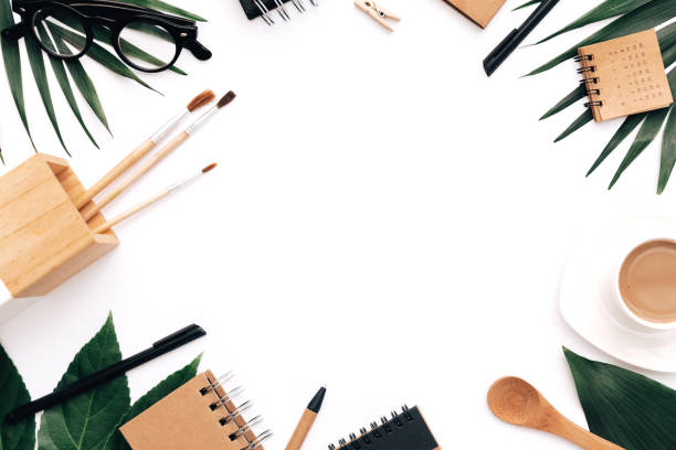 istock Flat lay blogger concept. Coffee, stationery, tropical leafs on white background. Minimal hipster concept 957482876