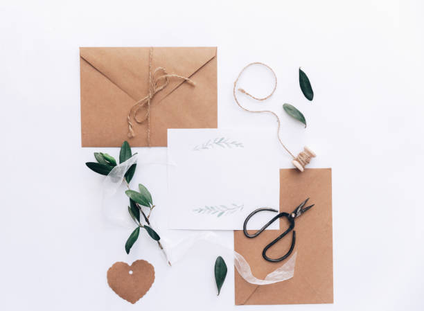 istock Trendy wedding invitation. Rustic invite with olive branch over white background. Flat lay, top view 957483392