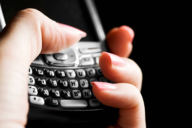 Text messaging on a wireless PDA smart phone stock photo
