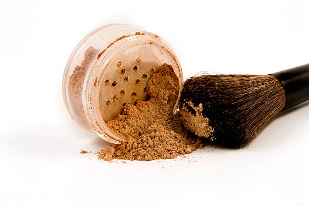 Mineral make-up spilled with brush stock photo