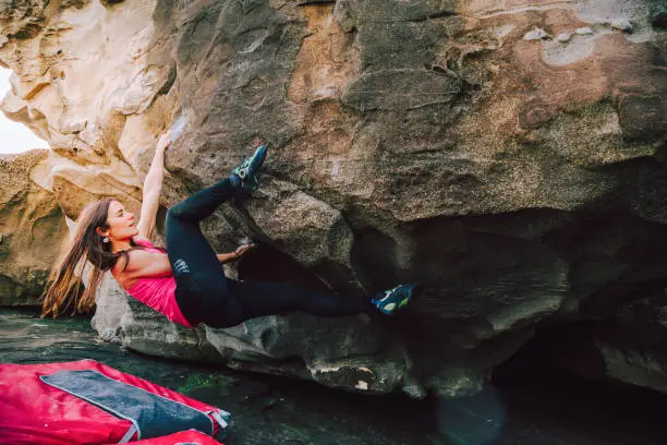 Photo of Brave young rock climber woman