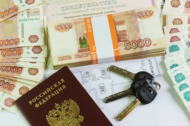 Photo of Inscription in Russian: Certificate of state registration of real estate. Passport, the plan and the keys to the large amount of Russian money