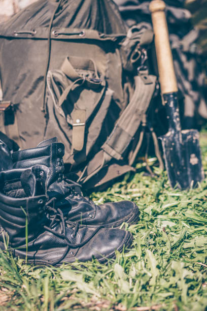 istock Army equipment, military boots, backpack and shovel 957505444