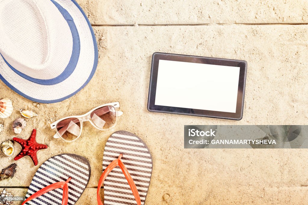beach, sand, background, summer vacation, tablet, travel, cope space Summer vacation composition. Sandals, sunglasses, hat, tablet and smartphone. cope space top view Beach Stock Photo