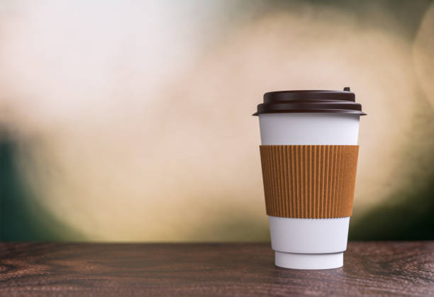 istock coffee takeaway on the table - bokeh background - 3d illustration rendering 957531038