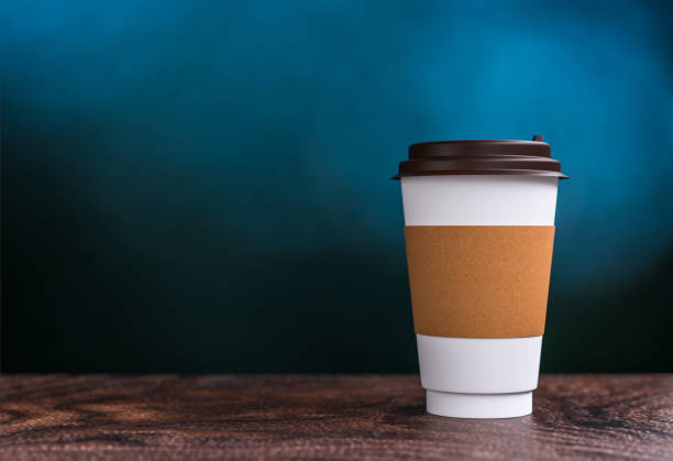 istock coffee takeaway on the table - bokeh background - 3d illustration rendering 957531052