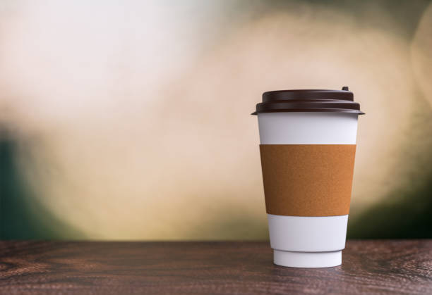 istock coffee takeaway on the table - bokeh background - 3d illustration rendering 957531072