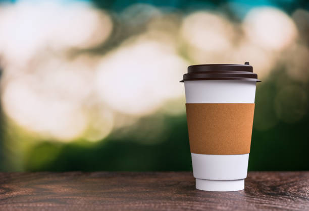 istock coffee takeaway on the table - bokeh background - 3d illustration rendering 957531092