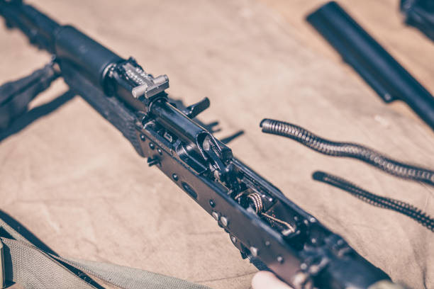 istock The boy performs disassembly, cleaning and assembly of automatic rifle 957531878