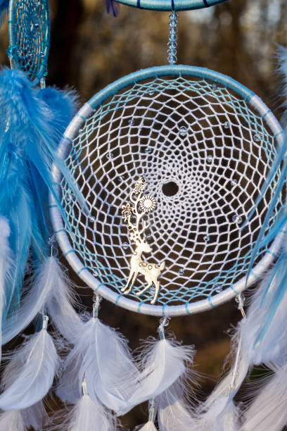 istock Handmade dream catcher with feathers threads and beads rope hanging 957532488