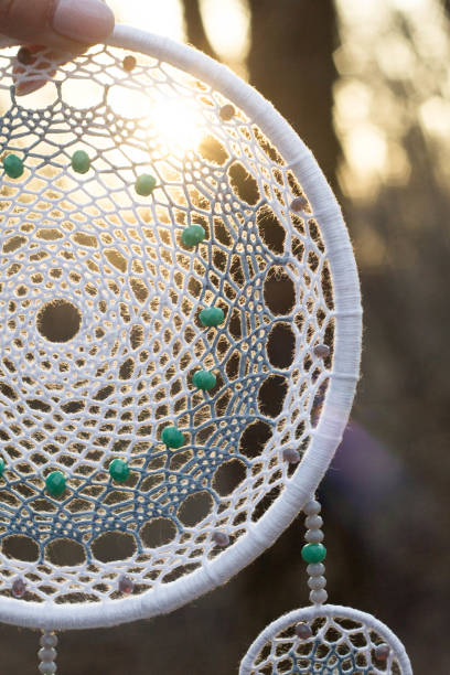 istock Handmade dream catcher with feathers threads and beads rope hanging 957532646
