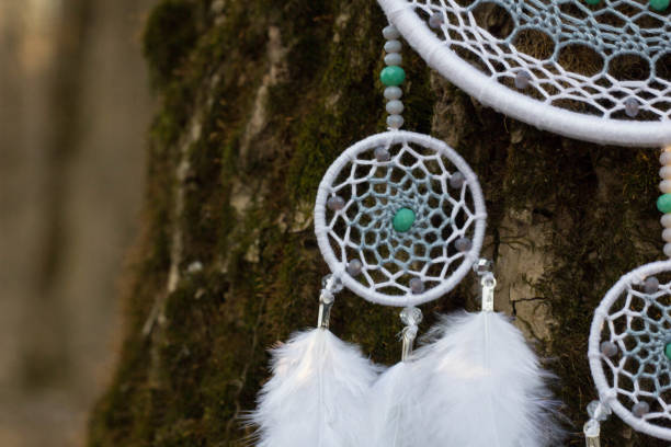 istock Handmade dream catcher with feathers threads and beads rope hanging 957532676