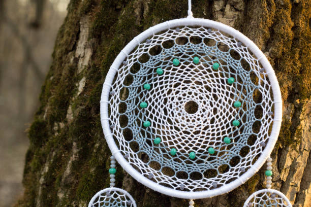 istock Handmade dream catcher with feathers threads and beads rope hanging 957532700